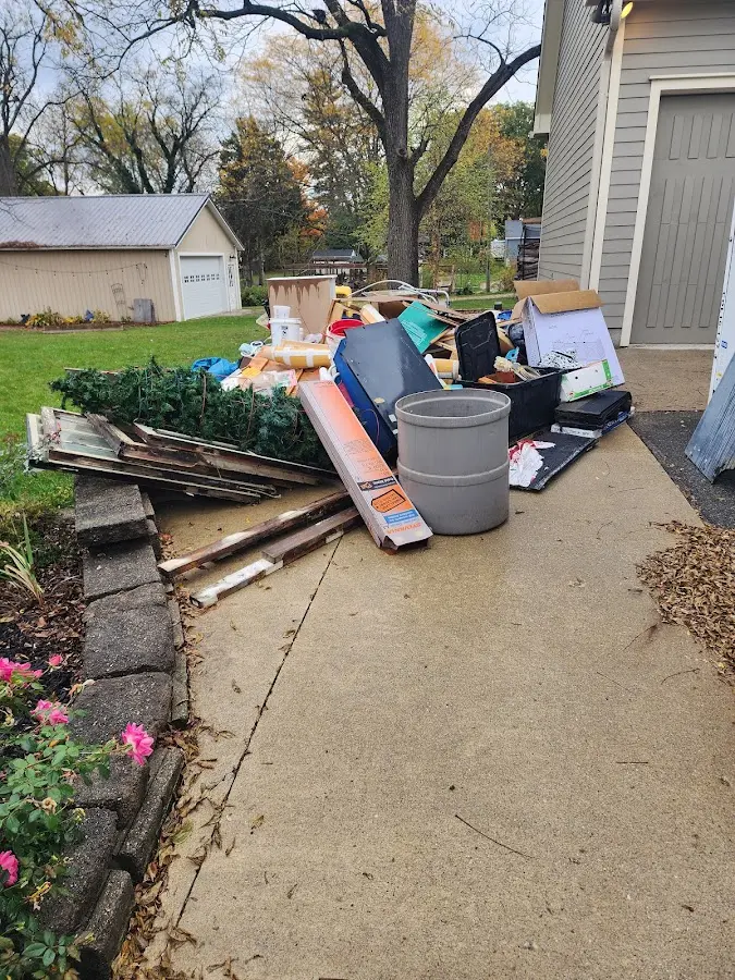Dumpster being loaded with debris for Estate Cleanout Dumpster Rental in Howards Grove